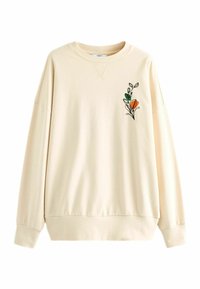 Kremowa bluza o luźnym kroju, z ozdobną kwiatową haftem po lewej stronie w zielonych i pomarańczowych odcieniach.