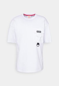 T-shirt bianca in cotone con maniche corte, scollo rotondo, taschino sul petto e patch del marchio nero. Presenta un accentuato anello per il fissaggio.
