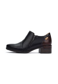Stivaletti in pelle nera alla caviglia con zip laterale, caratterizzati da un dettaglio marrone sul tallone e un tacco basso a blocco. Texture liscia e design elegante.