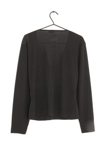 Svart långärmad topp i mjukt tyg med V-ringning. Har en rak nederkant och manschetter, hängande från en svart krok.