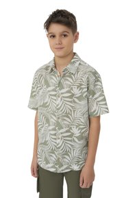 Camicia a maniche corte con bottoni, di base verde chiaro, con un motivo a foglie bianche. Realizzata in un tessuto traspirante adatto per il clima caldo.