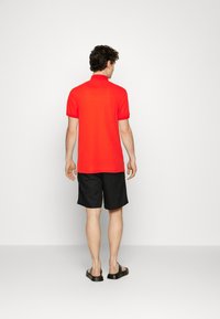 Tommy Hilfiger REGULAR - Polo - acid orange