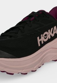 Black and pink Hoka running shoe with thick sole, visible laces, and the HOKA logo on the side.