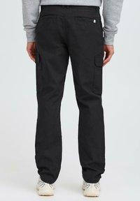 Black cargo pants with two side pockets and two rear pockets, straight-fit design, made from cotton, featuring a smooth texture.