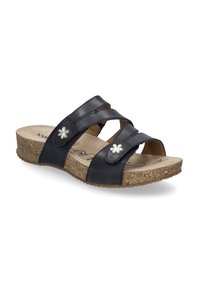 Sandales à glissière en cuir noir avec semelle en liège, dotées de trois sangles croisées et d'accents floraux sur le côté. Semelle intérieure douce et texturée.