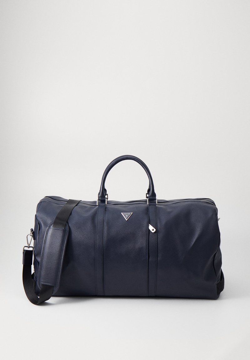 Geantă de duffel bleu marin din material synthetic neted, cu mâner dublu, curea ajustabilă și fermoar și accent de logo în nuanță argintie.