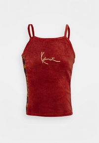 Top rosso senza maniche in tessuto vellutato con un design aderente. Presenta un logo dorato e un pannello laterale a motivi in verde e arancione.