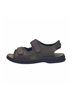 Brown open-toe sandal featuring fabric and leather materials, Velcro straps, textured accents, and a cushioned footbed on a flexible sole.