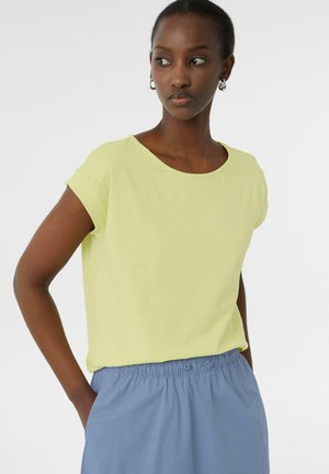 Yellow short-sleeve t-shirt with a round neckline, paired with a light blue, elastic waistband skirt featuring button accents.