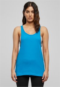 Top senza maniche di colore azzurro chiaro con scollo rotondo e vestibilità rilassata. Realizzato in tessuto morbido, presenta una superficie liscia e un design minimale.