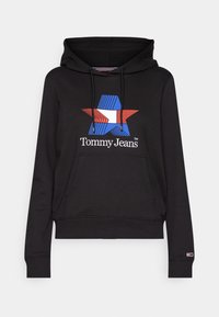 Sweat à capuche noir avec un grand logo étoile rouge et bleu accompagné du texte "Tommy Jeans" et une capuche réglable avec cordon. Tissu doux et poche kangourou.