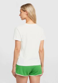 White cotton t-shirt with short sleeves and a crew neck, paired with green mesh shorts featuring a white trim. Visible stitching details.