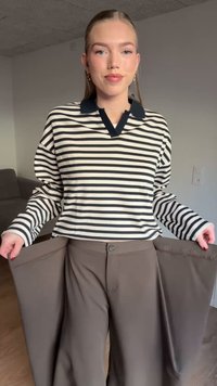 Striped long-sleeve top with a navy collar, paired with wide-fit brown trousers, featuring a button closure and flared leg openings.