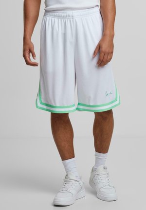 White athletic shorts with green stripe accents, elastic waistband, smooth texture, knee-length, featuring a logo on the lower left side.