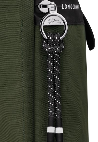 Green nylon bag with a black leather top, featuring a silver zipper and a rounded keyring. The adjustable black rope has white accents.