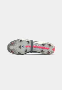 Football boot sole with a grey and pink design, featuring multiple cleats and a textured surface, secured with a black strap.