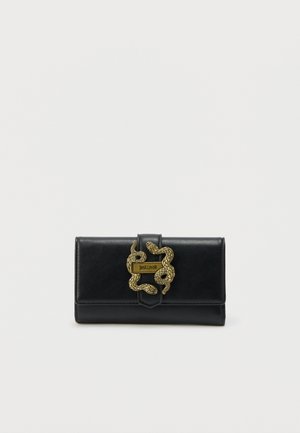 Black leather wallet with gold-tone double snake clasp and "Just Cavalli" logo plaque on front.