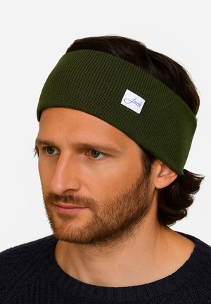 Dark green ribbed headband made of stretchy fabric, featuring a small white label with blue text. Fits snugly around the forehead.
