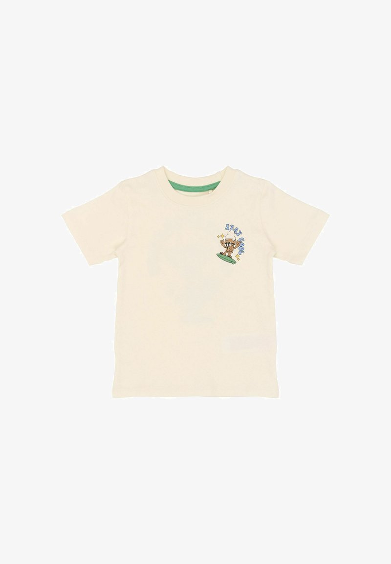 Κρεμ βαμβακερό T-shirt με κοντά μανίκια, πράσινο εσωτερικό λαιμόκοψη, με καρτούν γραφικό ενός σκύλου πάνω σε σανίδα του σερφ.