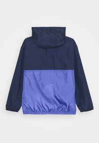 Navy and purple waterproof jacket with a hood, elasticized cuffs, and hem; features a two-tone design with a smooth texture.