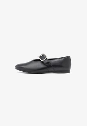 Black flat Mary Jane shoe with a silver buckle strap, rounded toe, and smooth leather texture, shown from the side on white background.