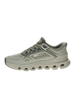 Light gray Skechers running shoe with mesh upper, cushioned sole featuring oval cutouts, and "SKECHERS ENGINEERED" branding on the side.