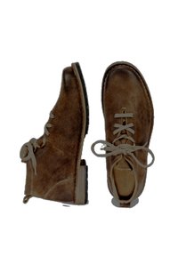 Brown leather ankle boots with a textured finish, round toe, and light beige laces. Solid rubber sole for durability.