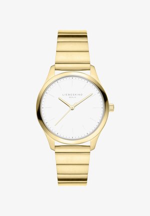 Orologio d'oro con cassa rotonda, quadrante bianco e lancette delle ore e dei minuti dorate. Presenta un bracciale in metallo dorato con texture e segmenti collegati.