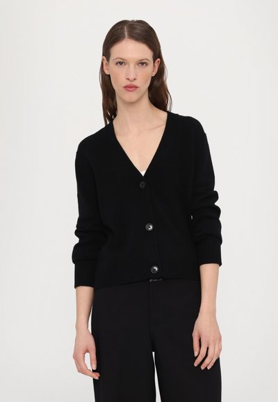 Black cardigan featuring a V-neck, long sleeves, and five-button front closure. Soft texture with ribbed cuffs and hem.