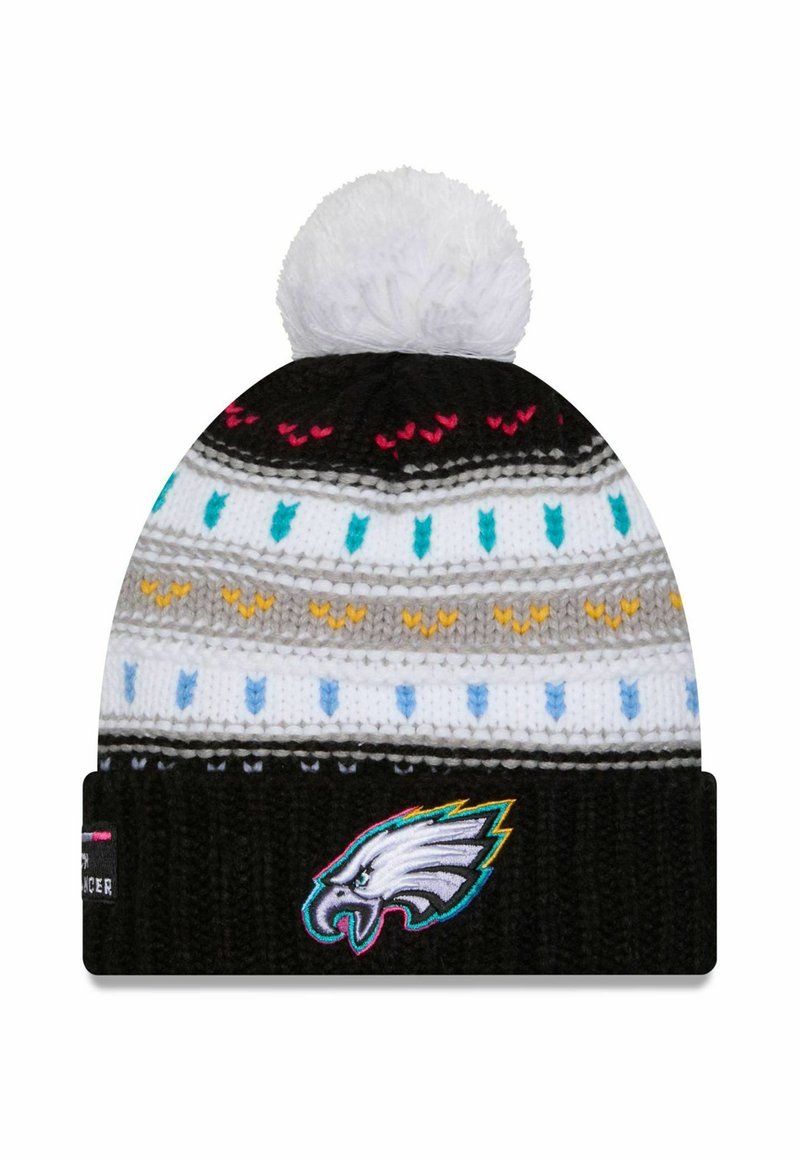 Strickmütze mit einem weißen Pompon, ausgestattet mit einem schwarzen Band mit gesticktem Adler-Logo und mehrfarbigen Musterrändern.