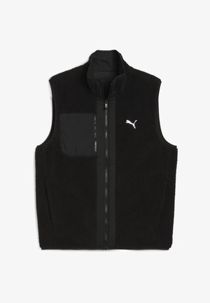 Chaleco negro con un frente de forro polar texturizado y una parte posterior de tela lisa. Cuenta con un cuello alto, bolsillos con cierre y un pequeño logo blanco.