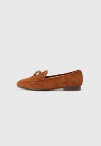 Brown suede loafer with a rounded toe, small heel, and decorative knot detail on the front. Smooth texture with a simple design.