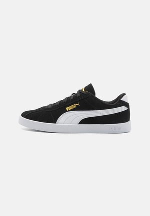 Black suede sneaker with white and gold accents, featuring a low-top design and rubber sole. Side logo detail enhances the design.