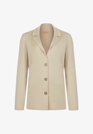 Beige strikket blazer med en klapkrave, præget af fire brune knapper og lange ærmer, lavet af blødt, tekstureret stof.