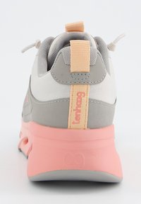Sneaker grigio chiaro con una parte superiore testurizzata, suola rosa e linguetta arancione. Presenta un tallone liscio e un marchio discreto sul retro.