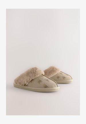 Beežid sussid kunstkarusnahaga mansetiga, pehme välispinna, reljeefsete loomamustrite ja madala profiiliga kummipõhjaga.