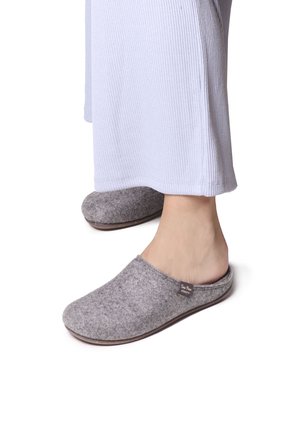 Gray felt slippers with a slip-on design, rounded toe, and a low heel. Features a fabric label on the side and a smooth sole.