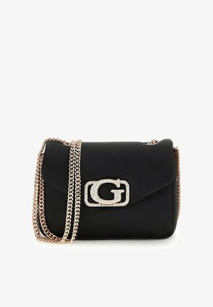 Sac à épaule noir avec une bandoulière chaîne dorée et un fermoir logo "G" décoratif en or et strass sur le rabat avant.