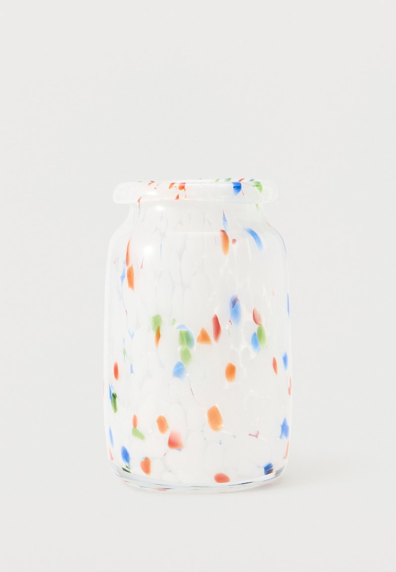 Bocal en verre transparent avec des motifs colorés de confettis en bleu, orange et vert sur un fond blanc.