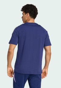 Marineblå kortærmet t-shirt lavet af bomuld med rund halsudskæring. Har raglanærmer og en glat tekstur.