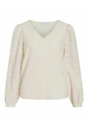 Blusa color crema con scollatura a V, maniche lunghe a sbuffo e motivi a diamante testurizzati in tutto il capo. Orlo flessibile con polsini elasticizzati.