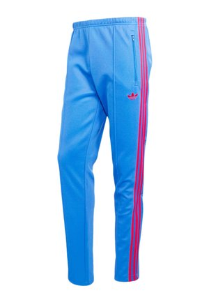 Niebieskie spodnie sportowe z czerwonymi paskami po bokach, zapinanym na zamek bocznym kieszenią, elastyczną talią i małym czerwonym logo na udzie.