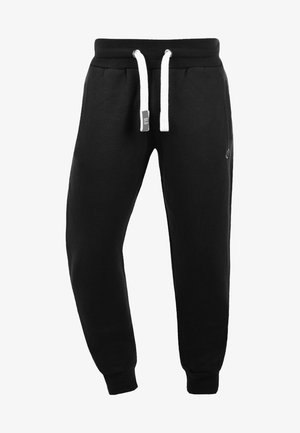 Schwarze Sweatpants mit einem Kordelzugbund, weißen Akzenten, zwei Fronttaschen, gerippten Bündchen und einem Logo an der Seite. Hergestellt aus weichem Baumwollmaterial.