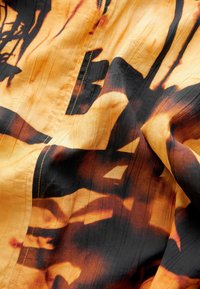 Next Päevakleit - ochre yellow and black print