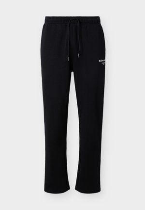 Μαύρη φόρμα με ελαστική μέση και κορδόνι, με μικρό λευκό κείμενο μάρκας στο πάνω μέρος του μηρού.