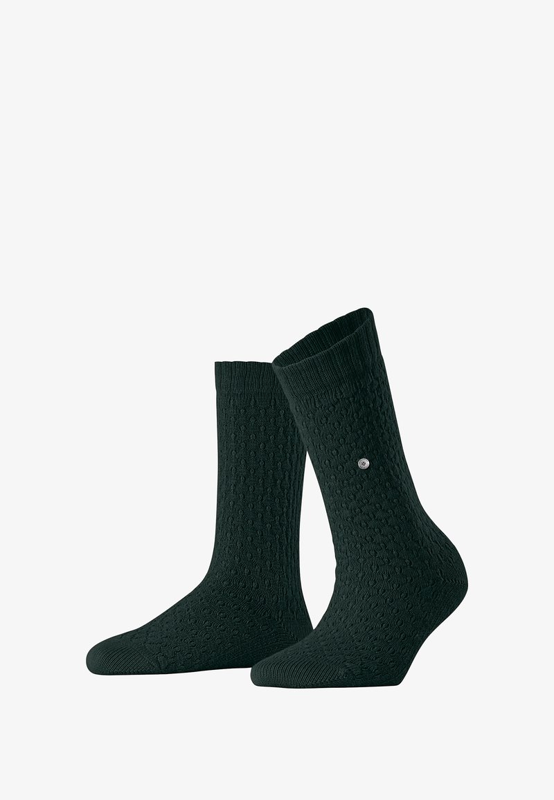 Chaussettes texturées vert foncé avec un bord côtelé ; assorties, l'une légèrement inclinée. Un petit logo apparaît sur le côté d'une chaussette.