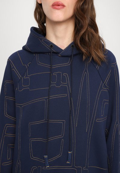 Navy blue hoodie made of soft fabric, featuring a geometric pattern in lighter stitching, with a drawstring hood and raglan sleeves.