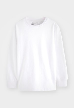 Wit katoenen T-shirt met lange mouwen, ronde hals en ribgebreide manchet. Eenvoudig ontwerp, onopgesmukt, lichtgewicht stof.