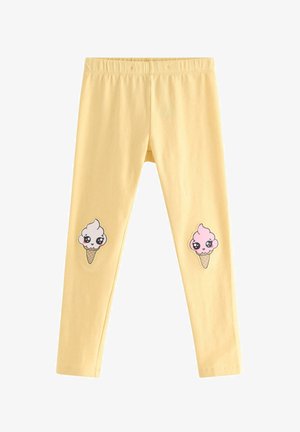 Gule leggings med elastisk linning med kawaii-stil hvide og pink isvaffel-patches på knæene.