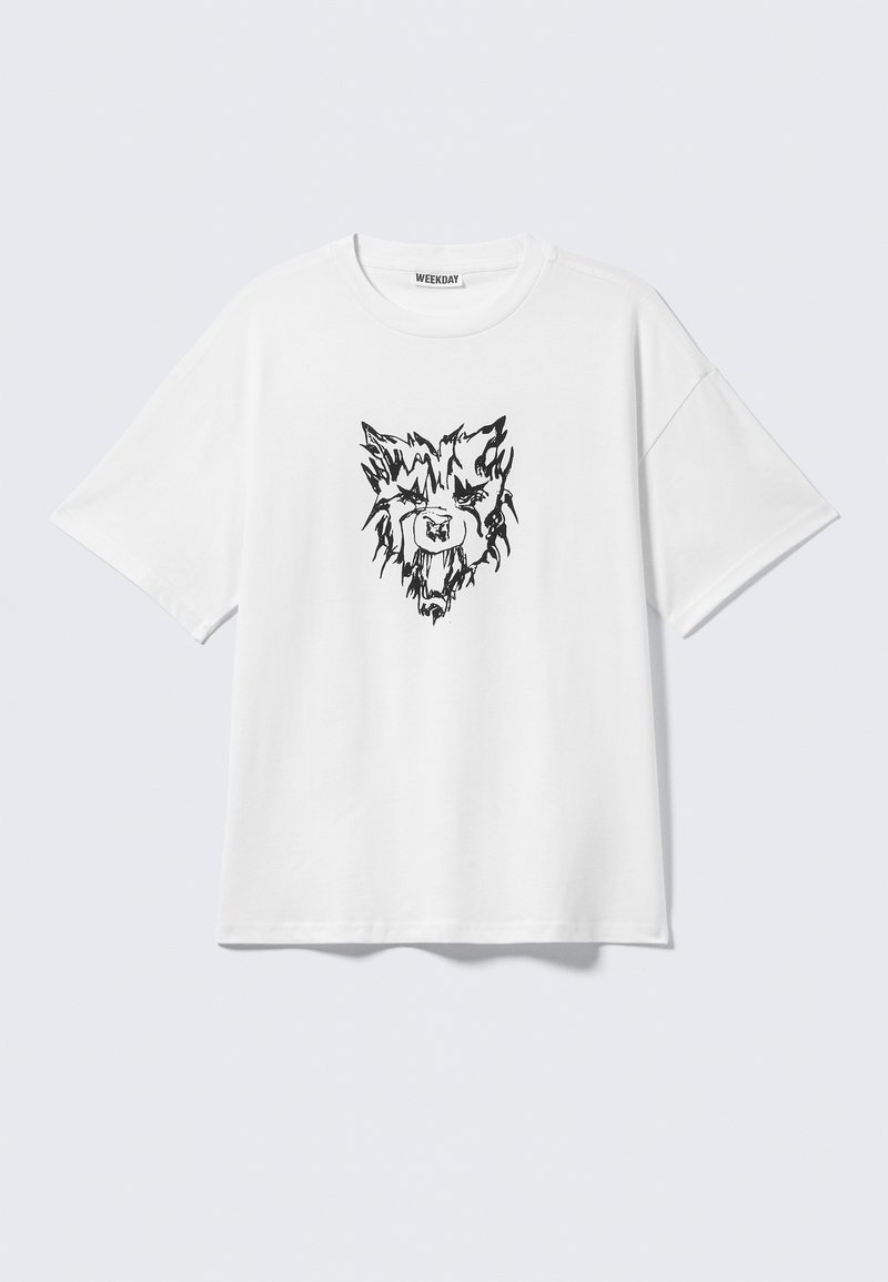 Vit bomulls-T-shirt med ett svart grafiskt tryck av ett lejonansikte på framsidan. Avslappnad passform med korta ärmar och rund halsringning.